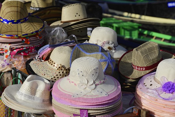 A colourful selection of different hats stacked and displayed for sale, Inle Lake, Myanmar, Asia