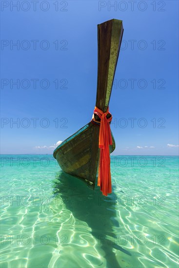 Longtail boat, fishing boat, wooden boat, decorated, tradition, traditional, faith, cloth, colourful, bay, sea, ocean, Andaman Sea, tropical, tropical, island, water, beach, beach holiday, Caribbean, environment, clear, clear, clean, peaceful, picturesque, sea level, climate, travel, tourism, paradisiacal, beach holiday, sun, sunny, holiday, dream trip, holiday paradise, paradise, coastal landscape, nature, idyllic, turquoise, Siam, exotic, travel photo, sandy beach, seascape, Phi Phi Island, Thailand, Asia