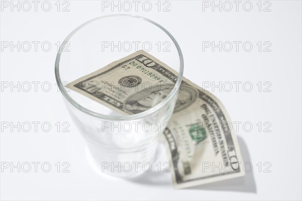 Ten Dollar Bill Inside and Outside of a Drink Glass