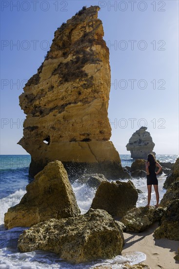 Young woman on summer holiday, emotion, rock, distance, view, sun, summer, summer holiday, holiday happiness, tourism, travel, symbolic, symbol, beach holiday, freedom, feeling of freedom, beach holiday, Algarve, Portugal, Europe
