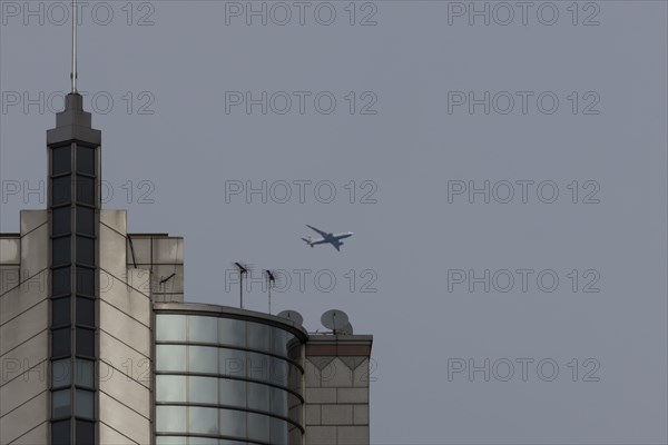 Airbus A319-100 aircraft of British airways in flight over a city skyscraper building, London, England, United Kingdom, Europe