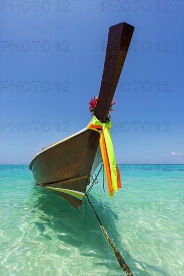 Longtail boat, fishing boat, wooden boat, boat, decorated, tradition, traditional, faith, cloth, colourful, bay, sea, ocean, Andaman Sea, tropics, tropical, island, water, beach, beach holiday, Caribbean, environment, clear, clean, peaceful, picturesque, sea level, climate, travel, tourism, paradisiacal, beach holiday, sun, sunny, holiday, dream trip, holiday paradise, paradise, coastal landscape, nature, idyllic, turquoise, Siam, exotic, travel photo, sandy beach, seascape, Phi Phi Island, Thailand, Asia