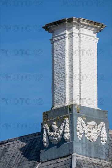Close-up of a white chimney with decorative elements on a grey roof, Middelburg, Zeeland, Netherlands