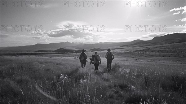 Three cowboys walk across a field with mountains in the backdrop at sunset, AI generated