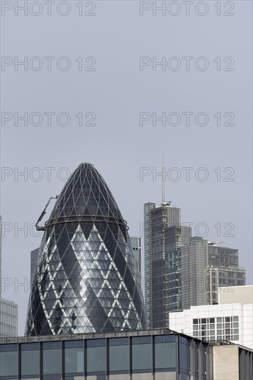 The Gherkin skyscraper building and nearby high rise office building, City of London, England, United Kingdom, Europe