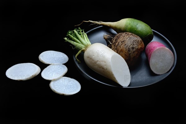 Various radishes on a plate, sliced, Raphanus