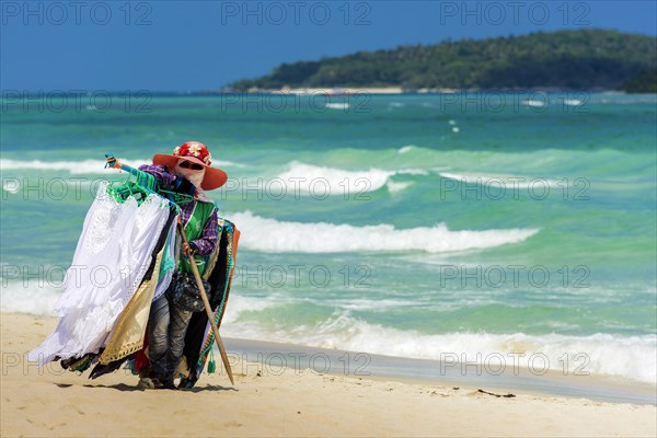 Trader on the beach selling clothes, sun protection, beach vendor, holiday, symbol, symbolic, sea, beach, clothes, summer, sun, summer holiday, Koh Samui, Thailand, Asia