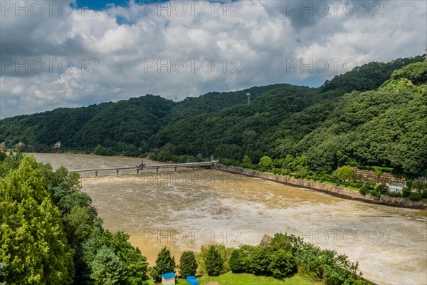 Landscape of flooded river under cloudy sky after torrential monsoon rains in Daejeon South Korea