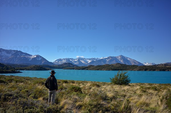 Hiker on the Circuito Azara looks out over the turquoise waters of Lake Belgrano, Perito Moreno National Park, Patagonia, Argentina, South America