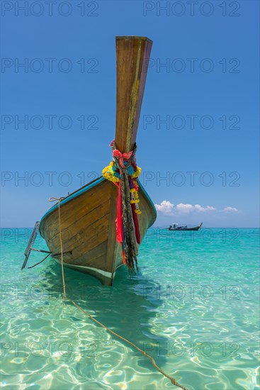 Longtail boat, fishing boat, wooden boat, decorated, tradition, traditional, faith, cloth, colourful, bay, sea, ocean, Andaman Sea, tropical, tropical, island, water, beach, beach holiday, Caribbean, environment, clear, clear, clean, peaceful, picturesque, sea level, climate, travel, tourism, paradisiacal, beach holiday, sun, sunny, holiday, dream trip, holiday paradise, paradise, coastal landscape, nature, idyllic, turquoise, Siam, exotic, travel photo, sandy beach, seascape, Phi Phi Island, Thailand, Asia