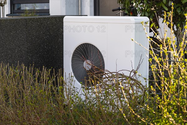 Heat pump in the front garden of a terraced house in Duesseldorf, North Rhine-Westphalia, Germany, Europe