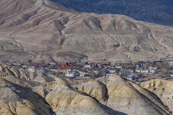 Lo Manthang, capital of Upper Mustang, viewed from a distance amidst a barren desertic landscape, Kingdom of Mustang, Nepal, Asia