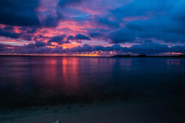 Beautiful sunset over ocean water taken from a beach in Guam