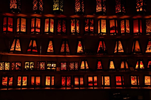 Rows of illuminated patterned lanterns casting a warm glow in a dark setting, Chiang mai, Thailand, Asia