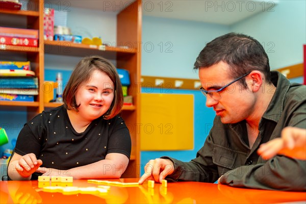People with special needs playing board skill games in a day center