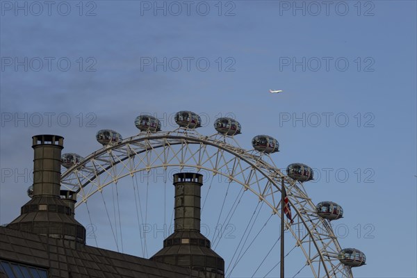 Airbus A319-100 aircraft of British airways in flight over the pods of the London Eye or Millennium Wheel, London, England, United Kingdom, Europe