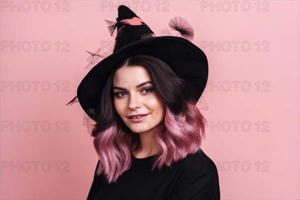 Portrait of young woman with black and pink hair wearing a Halloween costume witch hat in front of pastel pink background. KI generiert, generiert AI generated