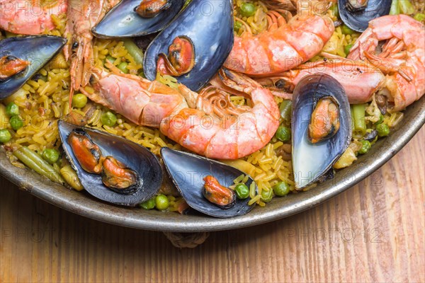 Freshly cooked seafood paella with vibrant colors served in a rustic pan, typical Spanish cuisine, Majorca, Balearic Islands, Spain, Europe