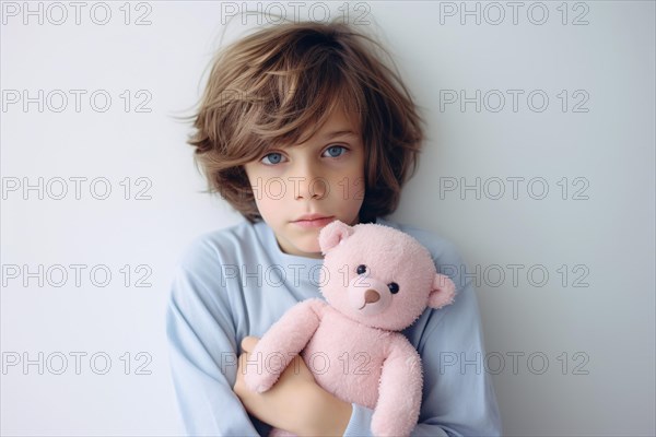 Young boy child with blue swater holding pink teddy bear. Concept for stereotypical colors for children. KI generiert, generiert AI generated