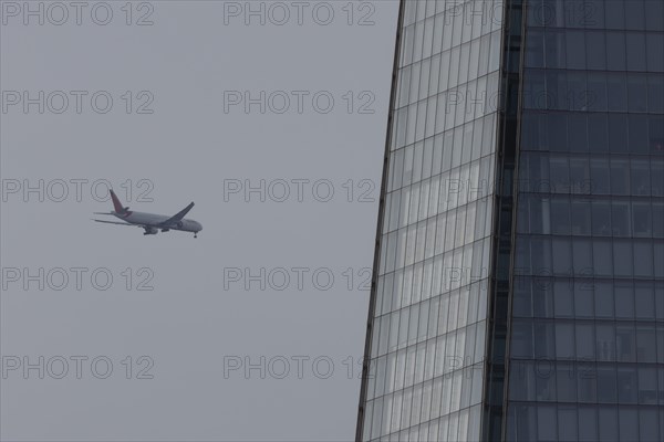 Aircraft of Air India airways in flight over The Shard city skyscraper building, London, England, United Kingdom, Europe