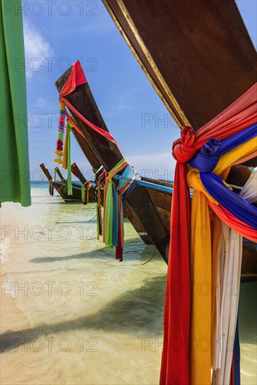 Longtail boat for transporting tourists, water taxi, taxi boat, ferry, ferry boat, fishing boat, wooden boat, boat, decorated, tradition, cloth, colourful, fabric, decorated, faith, superstition, traditional, bay, sea, ocean, Andaman Sea, tropics, tropical, chalk cliffs, landscape, island, water, travel, tourism, paradisiacal, beach holiday, sun, sunny, holiday, dream trip, holiday paradise, paradise, coastal landscape, nature, idyllic, turquoise, Siam, exotic, travel photo, Krabi, Thailand, Asia