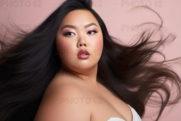 Curvy plus size Asian woman with long black hair in front of pink studio background. KI generiert, generiert AI generated