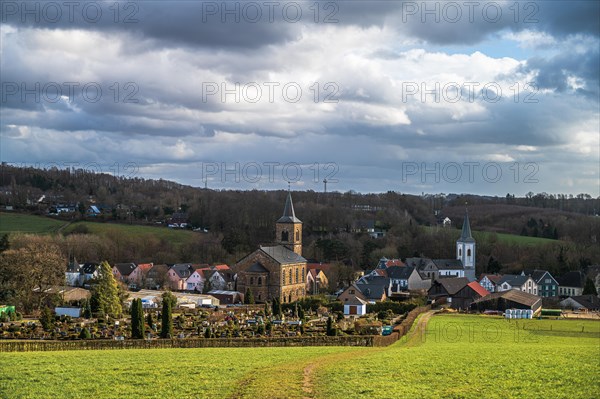 Picturesque view of a quiet village embedded in the green, rural landscape under a cloudy sky, Duessel village, Wuelfrath, Mettmann, North Rhine-Westphalia