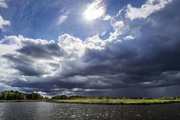 Dramatic changeable weather on the lake with cloudy sky, sun, cloud, light, light mood, atmosphere, play of light, sunbeams, thunderstorm, journey, holiday, boat, landscape, recreation, nature, nautical, seafaring, horizon, water, nobody, lonely, calm, freshwater, Masuria, Poland, Europe