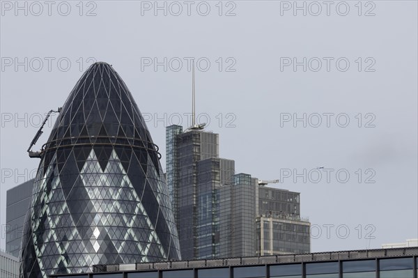 The Gherkin skyscraper building and nearby high rise office building, City of London, England, United Kingdom, Europe