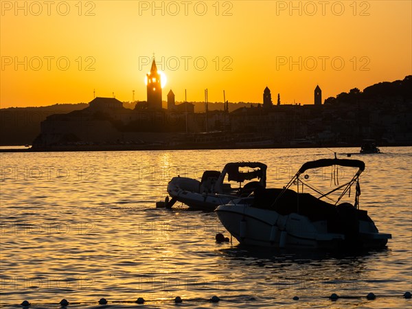 Boats anchoring in a bay, sunset, silhouette of the church towers of Rab, town of Rab, island of Rab, Kvarner Gulf Bay, Croatia, Europe