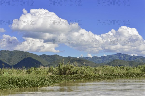 Vast landscape with river and mountains under a blue sky with clouds, Inle Lake, Myanmar, Asia