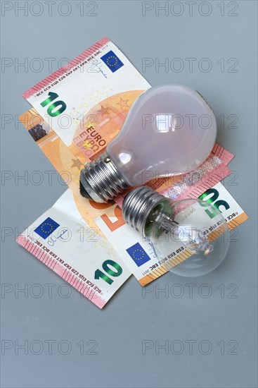 Banknotes and light bulbs, electricity costs