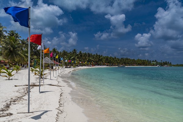 White sand beach with many flags, Bangaram island, Lakshadweep archipelago, Union territory of India