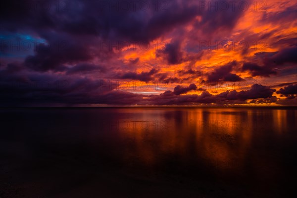 Beautiful sunset over ocean water taken from a beach in Guam