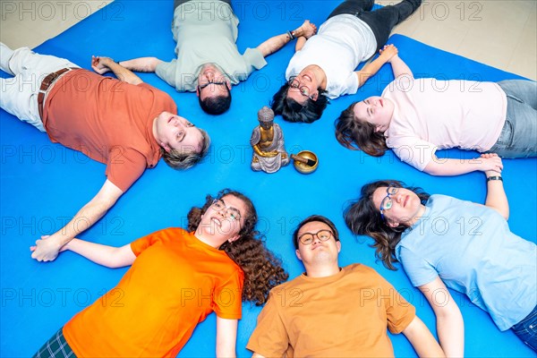 Disabled people lying on the mat during breathing exercises to relax on a gym