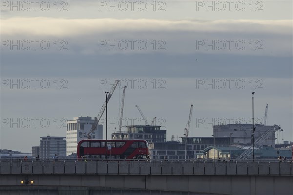 Red bus crosses over London Bridge, City of London, England, United Kingdom, Europe