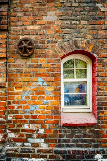 Window in brick house of Nikiszowiec, mining district of Katowice, Poland, Europe