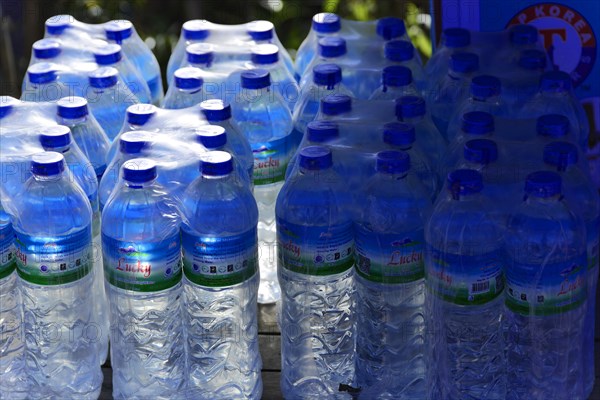 Stack of blue water bottles in a stall, Pindaya, Inle Lake, Myanmar, Asia