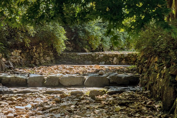 Dry rocky man made riverbed in wooded recreational forest in South Korea