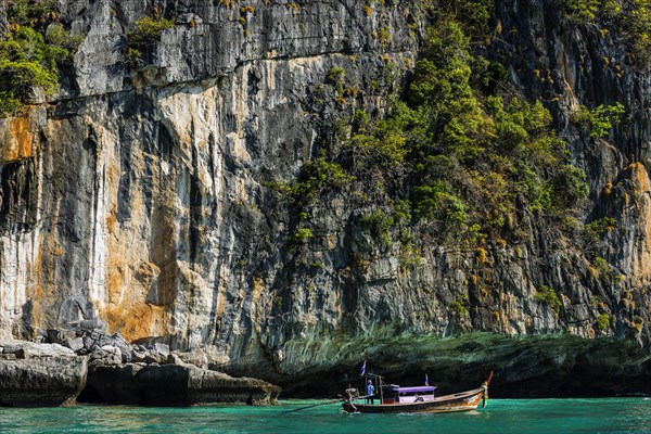 Fisherman on a longtail boat at Maya Bay, boat, wooden boat, local, tradition, Thai, Asian, traditional, sea, ocean, Andaman Sea, tropics, tropical, island, rock, cliff, water, fishing boat, travel, tourism, holiday, dream trip, holiday paradise, flora, paradise, coastal landscape, nature, idyllic, turquoise, Siam, exotic, travel photo, Ko Phi Phi Don, Thailand, Asia