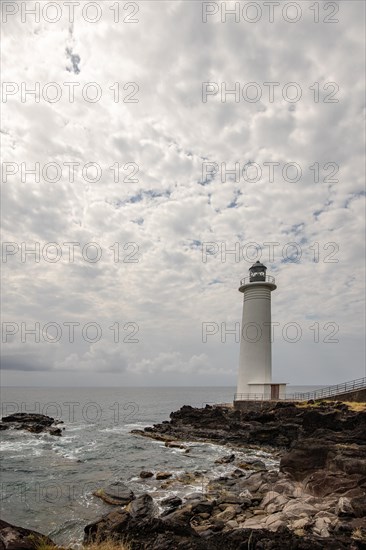 White lighthouse on a steep coast. Dramatic clouds with a view of the sea, pure Caribbean at Le Phare du Vieux-Fort, on Guadeloupe, French Antilles, France, Europe