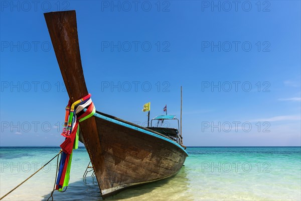 Longtail boat, fishing boat, wooden boat, boat, decorated, tradition, traditional, faith, cloth, colourful, bay, sea, ocean, Andaman Sea, tropics, tropical, island, water, beach, beach holiday, Caribbean, environment, clear, clean, peaceful, picturesque, sea level, climate, travel, tourism, paradisiacal, beach holiday, sun, sunny, holiday, dream trip, holiday paradise, paradise, coastal landscape, nature, idyllic, turquoise, Siam, exotic, travel photo, sandy beach, seascape, Phi Phi Island, Thailand, Asia