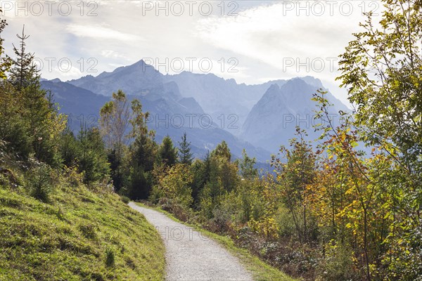 Wetterstein mountains with Alpspitze, Zugspitze massif and houses with hiking trail Philosophenweg, autumn, backlight, Garmisch-Partenkirchen, Upper Bavaria, Bavaria, Germany, Europe