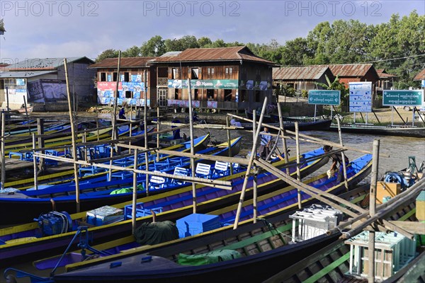 Parked boats on wooden poles on a quiet riverbank, Inle Lake, Myanmar, Asia