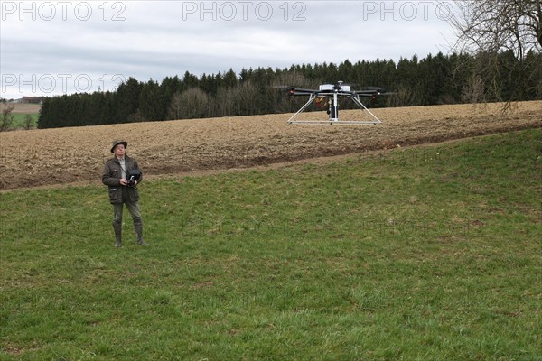 Hunter observes and controls flying drone during a hare (Lepus europaeus) census, Lower Austria, Austria, Europe