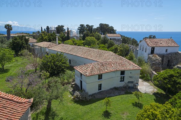 Mediterranean architecture with churches and houses, surrounded by trees under a blue sky, view of the Holy Monastery of Timi Prodromos, Byzantine fortress, nunnery, Koroni, Pylos-Nestor, Messinia, Peloponnese, Greece, Europe
