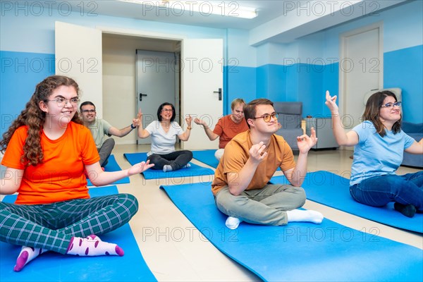 Disabled people enjoying practicing lotus pose during yoga class together
