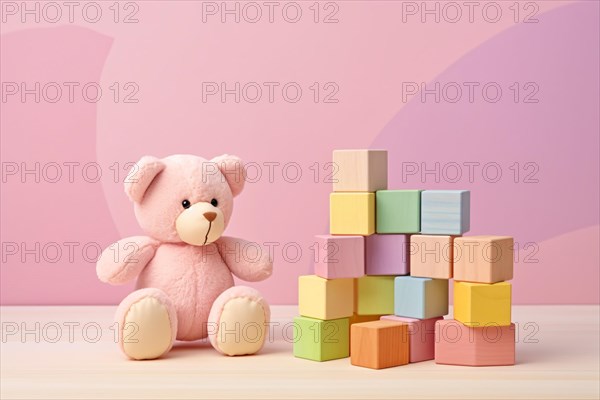 Pink children's toy teddy bear and colorful stacking stones on pastel pink background. KI generiert, generiert AI generated