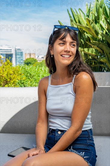 Portrait of a woman sitting on a couch with her ands togehter Vertical shot