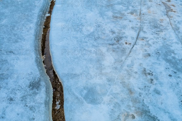 Texture of ice with a large crack on a frozen surface, in South Korea